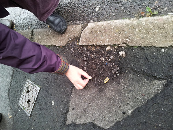 Hole in pavement of depth 2cm, tested with pound coin Hole in pavement of depth 2cm, tested with pound coin